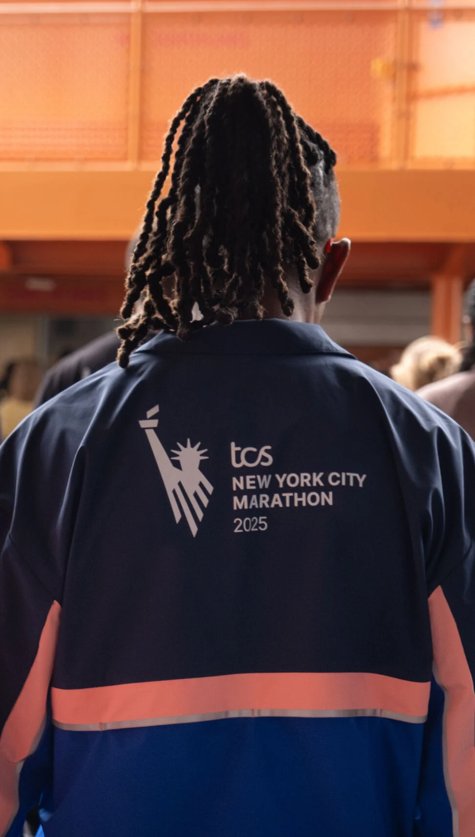 Two men wearing New York City Marathon apparel 